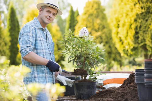 Technician inspecting hedge trimming equipment before work